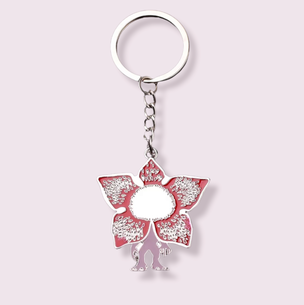 Calling all Stranger Things fans! Now I know the demogorgon is supposed to be terrifying but I couldn't resist getting in this adorable guy. I'm sure you can't resist those cute little teeth either. Pendant Size Roughly 4.3cm. Material: Zinc Alloy and enamel.
