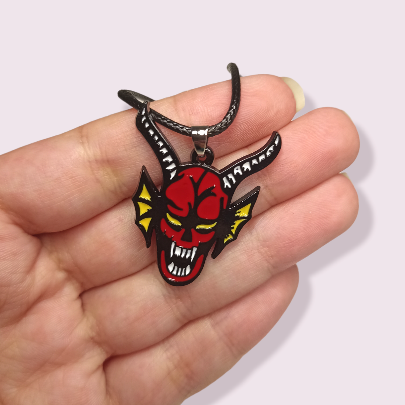 Calling all Stranger Things fans! If you've watched the most recent season, you'll know why I'm so excited about this item. Inspired by the DnD club featured in season 4, this is a must have collectable for any ST fan. Pendant Size Roughly 3x3.5cm. Material: Zinc Alloy and enamel.