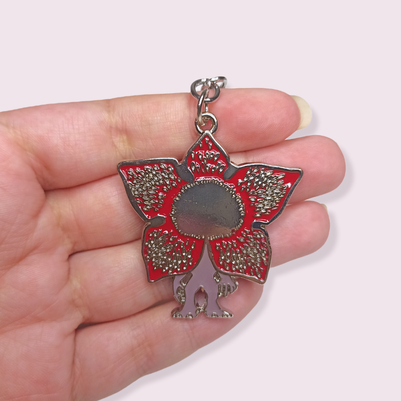 Calling all Stranger Things fans! Now I know the demogorgon is supposed to be terrifying but I couldn't resist getting in this adorable guy. I'm sure you can't resist those cute little teeth either. Pendant Size Roughly 4.3cm. Material: Zinc Alloy and enamel.