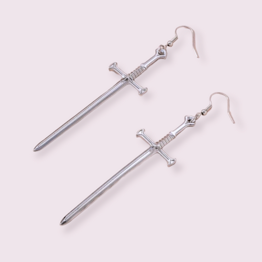 Make a statement with these stunning sword earrings, perfect for anyone trying to edge up their jewellery collection. Pendant size roughly 5.5cm for Medium and 8cm for Large. Material: zinc alloy. If you have a nickel allergy, please add a note to your order at checkout and I’ll switch the alloy hooks to nickel free hooks.