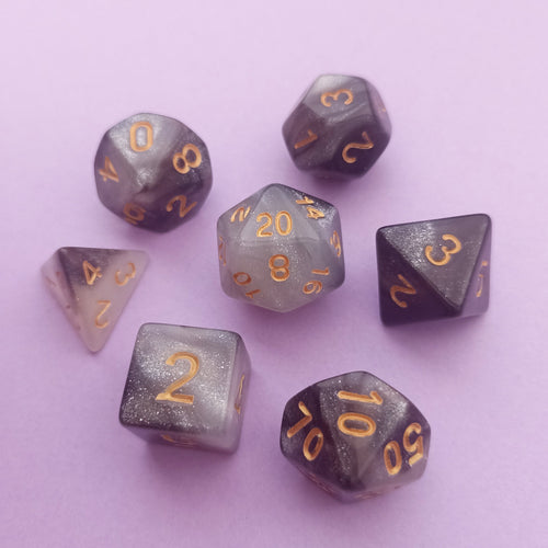 This set is a mixture of different grey shimmer hues resembling the galaxy.

We're trying out something new and these stunning limited addition resin DnD dice are just a little teaser before we hopefully launching our own custom dice range later this year. All of our dice will be limited and mostly will not be restocked as each batch comes out differently. Please note each set will be different to the next depending on the pour.