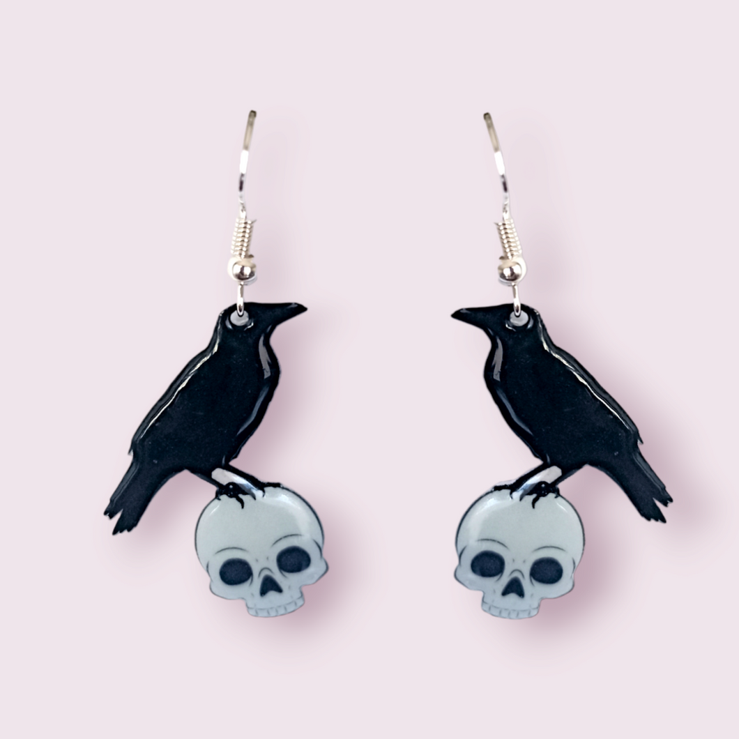 If you've been around a while, you'll notice the adorable raven in these earrings, is the same one found on my logo. These stunning earrings are designed and made in-house. Material: shrink film, resin, nickel free hooks. Please note as these are all handmade, minor differences may occur from piece to piece.  All shrink film products can take about a week to send out as they are currently made to order