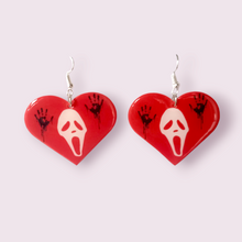 Load image into Gallery viewer, Inspired by my favourite slasher killer, Ghostface. These stunning earrings are designed and made in-house. Material: shrink film, resin, nickel free hooks. Size 4x4.5cm. Please note as these are all handmade, minor differences may occur from piece to piece.
