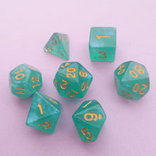 Load image into Gallery viewer, This set may look green upon first glance but has a pearlescent blue tint when the light hits it.

We&#39;re trying out something new and these stunning limited addition resin DnD dice are just a little teaser before we hopefully launching our own custom dice range later this year. All of our dice will be limited and mostly will not be restocked as each batch comes out differently. Please note each set will be different to the next depending on the pour.
