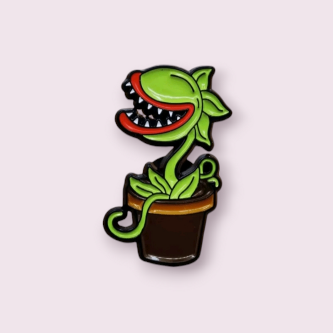 This stunning pin is inspired by the charismatic plant, Audrey 2, coming from the captivating musical Little Shop of Horrors. This pin is sure to delight my fellow theatre nerds. Size roughly 3.1x1.8cm. Material: enamel