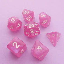Load image into Gallery viewer, This set may look purely pink upon first glance but has a pearlescent purple tint when the light hits it.

We&#39;re trying out something new and these stunning limited addition resin DnD dice are just a little teaser before we hopefully launching our own custom dice range later this year. All of our dice will be limited and mostly will not be restocked as each batch comes out differently. Please note each set will be different to the next depending on the pour.
