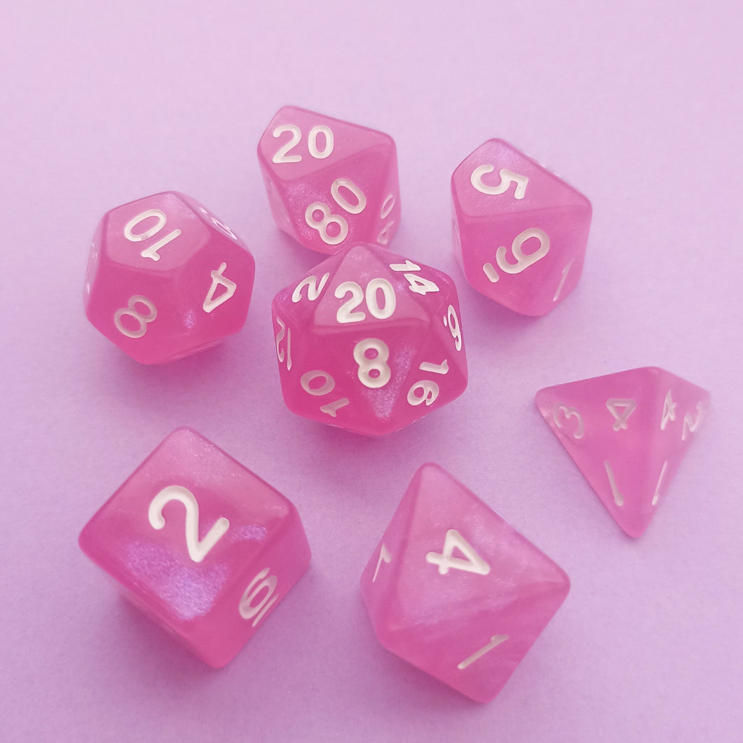 This set may look purely pink upon first glance but has a pearlescent purple tint when the light hits it.

We're trying out something new and these stunning limited addition resin DnD dice are just a little teaser before we hopefully launching our own custom dice range later this year. All of our dice will be limited and mostly will not be restocked as each batch comes out differently. Please note each set will be different to the next depending on the pour.