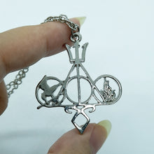 Load image into Gallery viewer, Do you have a geeky a friend in your life and you don’t know what to get them? We’ve got you covered. This necklace includes symbols from five major fandoms, those being: Harry Potter, Percy Jackson, The Hunger Games, Divergent and Mortal Instruments / Shadow Hunters. Pendant size roughly 4x3.5cm. Material: Zinc Alloy
