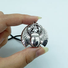 Load image into Gallery viewer, A unique gift for those who are drawn to Egyptian symbolism. The god Ra (Khepri), was often depicted as a scarab or as a scarab headed man. Pendant Size Roughly 3.5x3cm. Material: zinc alloy 
