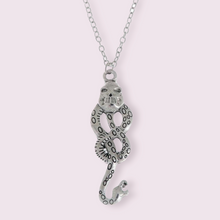 Load image into Gallery viewer, This stunning necklace is inspired by the dark mark which Voldemort uses to summon his followers. The perfect staple piece for any Harry Potter fan. Material: Zinc Alloy. Pendant size roughly 5x2.7cm
