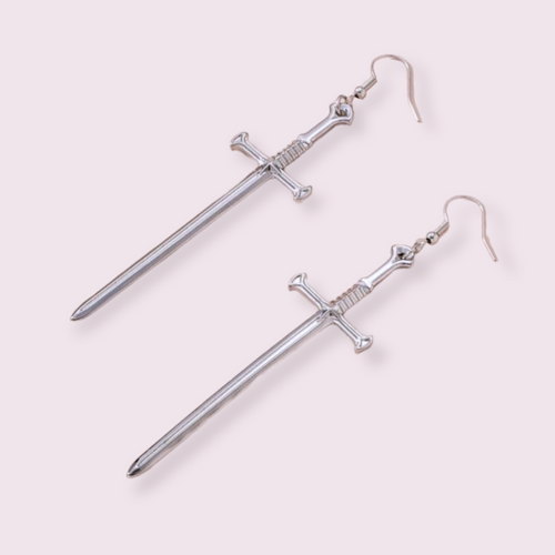 Make a statement with these stunning sword earrings, perfect for anyone trying to edge up their jewellery collection. Pendant size roughly 5.5cm for Medium and 8cm for Large. Material: zinc alloy. If you have a nickel allergy, please add a note to your order at checkout and I’ll switch the alloy hooks to nickel free hooks. 